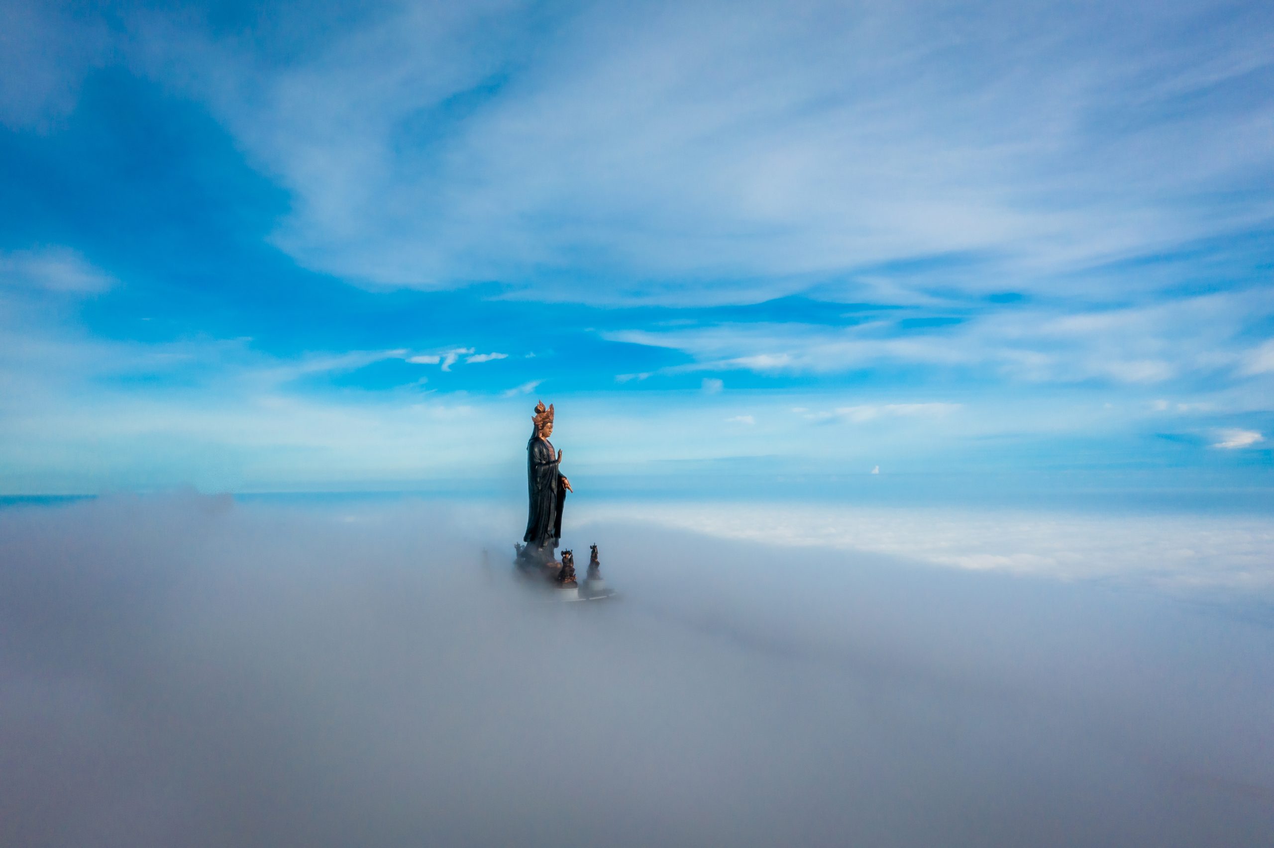 Bodhisattva statue above the clouds on Ba Den Mountain